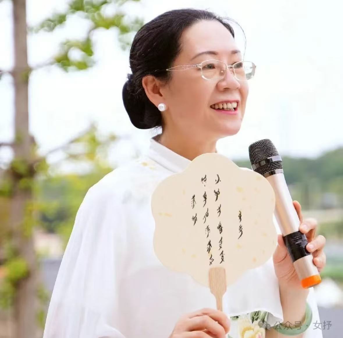 老人持毛笔在宣纸上书写纤细笔画